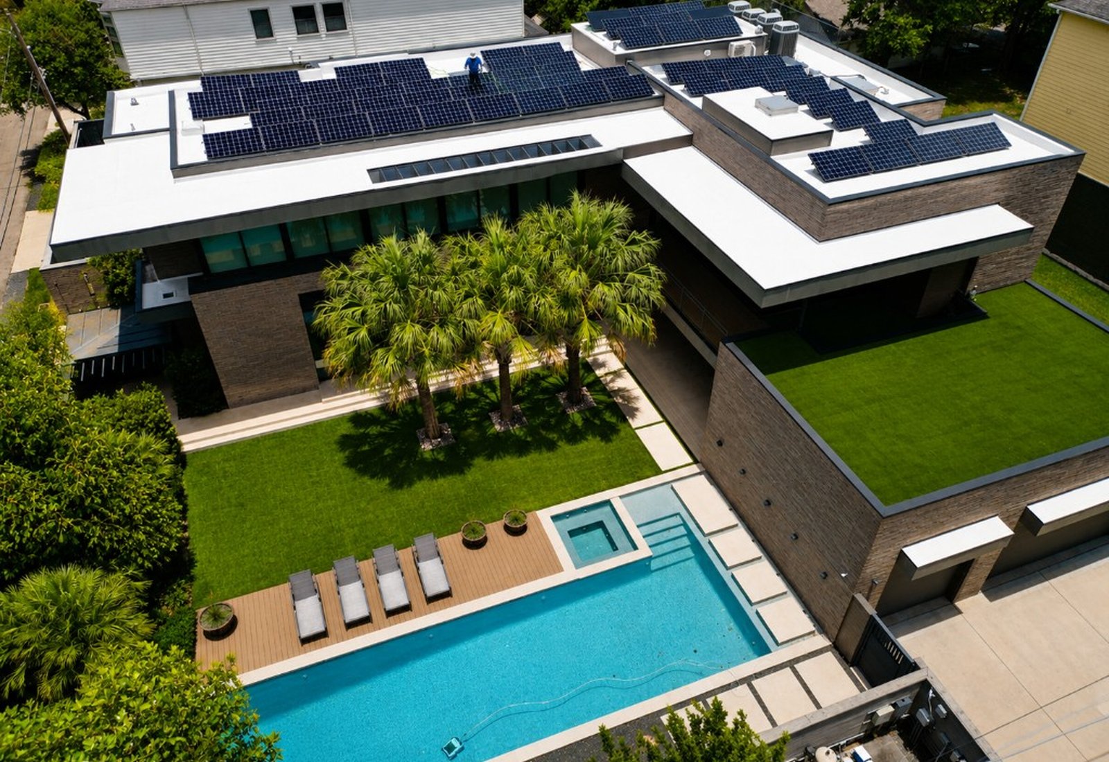 Clean patio and pool deck with rooftop solar panels